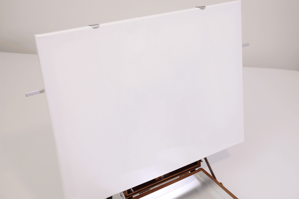 White painting canvas on the easel box stand with a neutral background