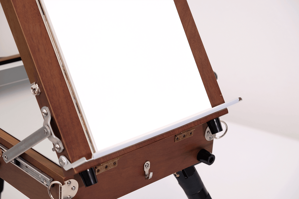 Wooden artist's easel with a white canvas on a white background